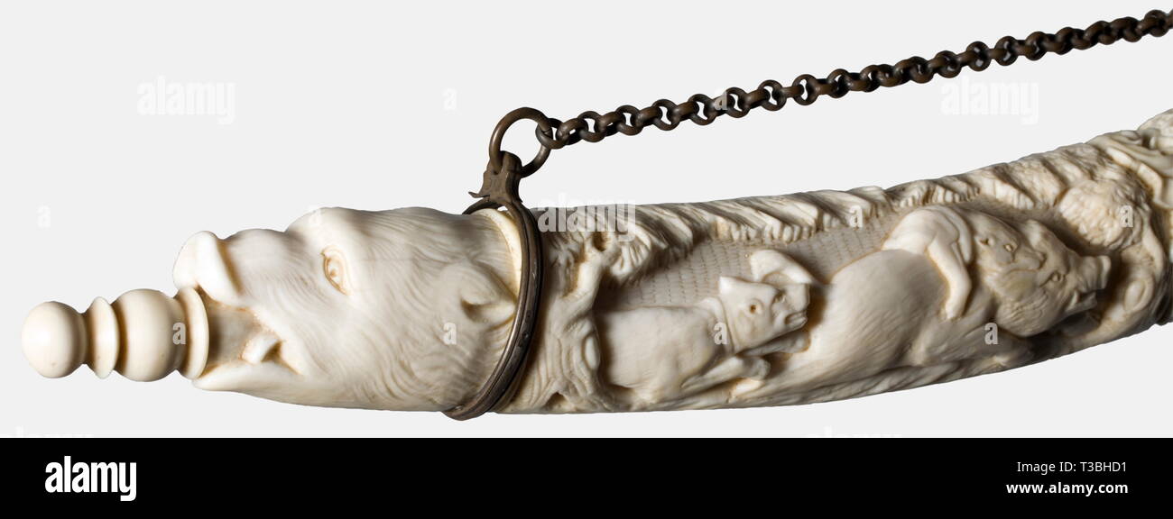 A splendid Polish powder horn, 1st half of the 19th century. A finely carved horn of walrus(?) ivory in the baroque style. Both sides display hunting scenes in half relief, showing hounds fighting with a boar and with wolves, above a hunting trophy bundle or the crowned coat of arms for Poland/Lithuania. Nozzle carved in the shape of a wild boar's head. Silver suspension chain, bands bearing the Russian hallmark '84'. Restored break at the lower end. Length 40 cm. historic, historical, 19th century, powder flask, accessory, accessories, military,, Additional-Rights-Clearance-Info-Not-Available Stock Photo