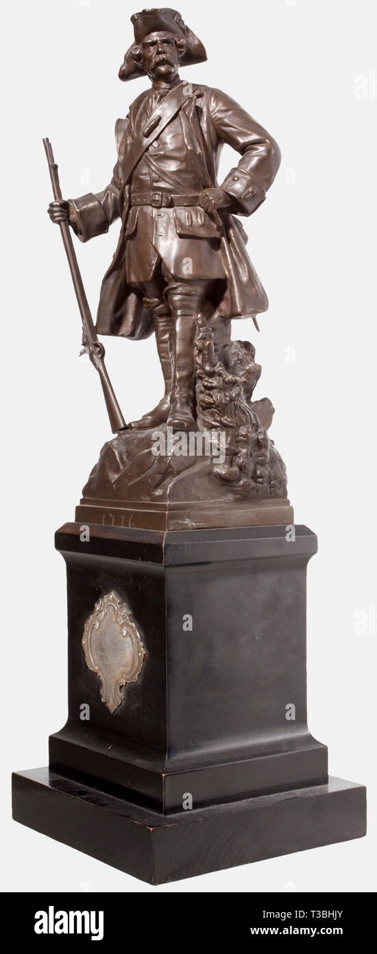 An officer's leaving present, dated 1909, Infantry Regiment Alt-Württemberg (3. Württ.) no. 121 Bronze figure of a soldier from the 1st half of the 18th century, his glance turned rightward and holding his musket, behind him a fascine, laterally marked '1899 Frh. v. Ellrichshausen'. On a square plinth marked '1716'. The base of ebonised wood, the viewing side bears a silver dedication plaque decorated in rocaille 'Die Offiziere und Sanitätsoffiziere des Infanterie-Regiments Alt-Württemberg dem scheidenden Hauptmann Soecht 27.5.89 - 26.8.09' (The Offic, Artist's Copyright has not to be cleared Stock Photo