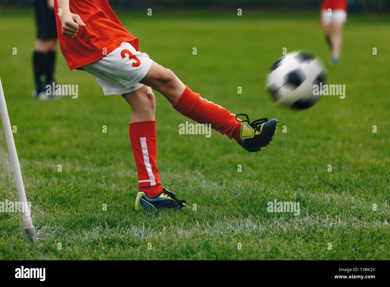 Soccer Corner Kick on the Grass Field. Player Kicking Soccer Ball on