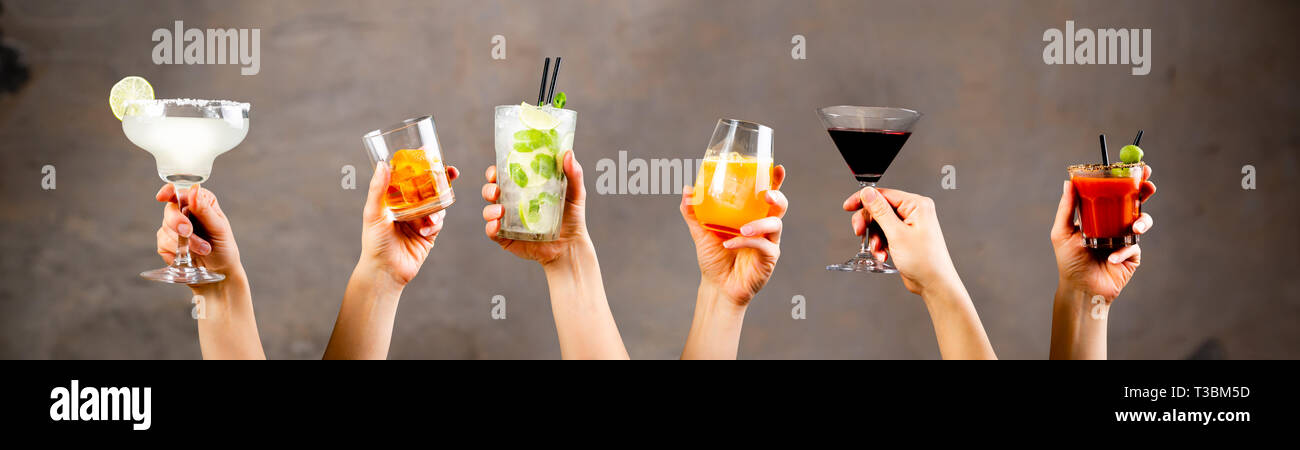 Hands holding classic cocktails on rustic background Stock Photo