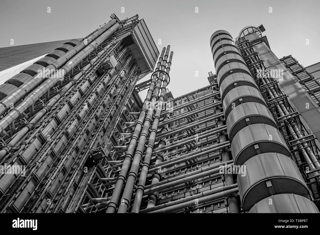 A modern towering steel pipe office structure stretching towards the London Finance district Sky Stock Photo