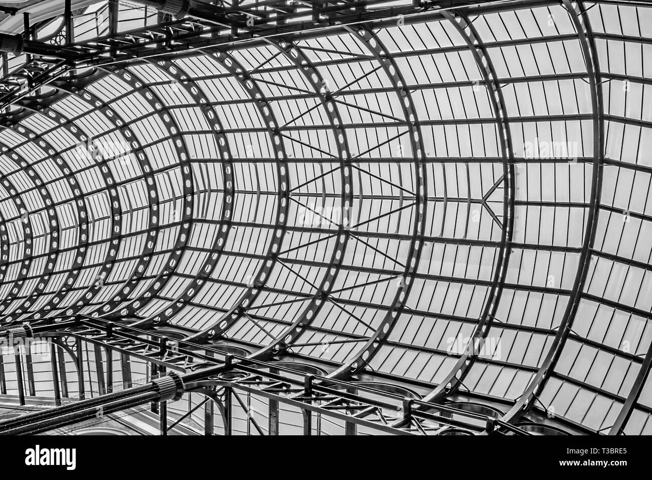 A black and white view of the metal framework and glass covered roof over the Galleria, Southwark,London Stock Photo