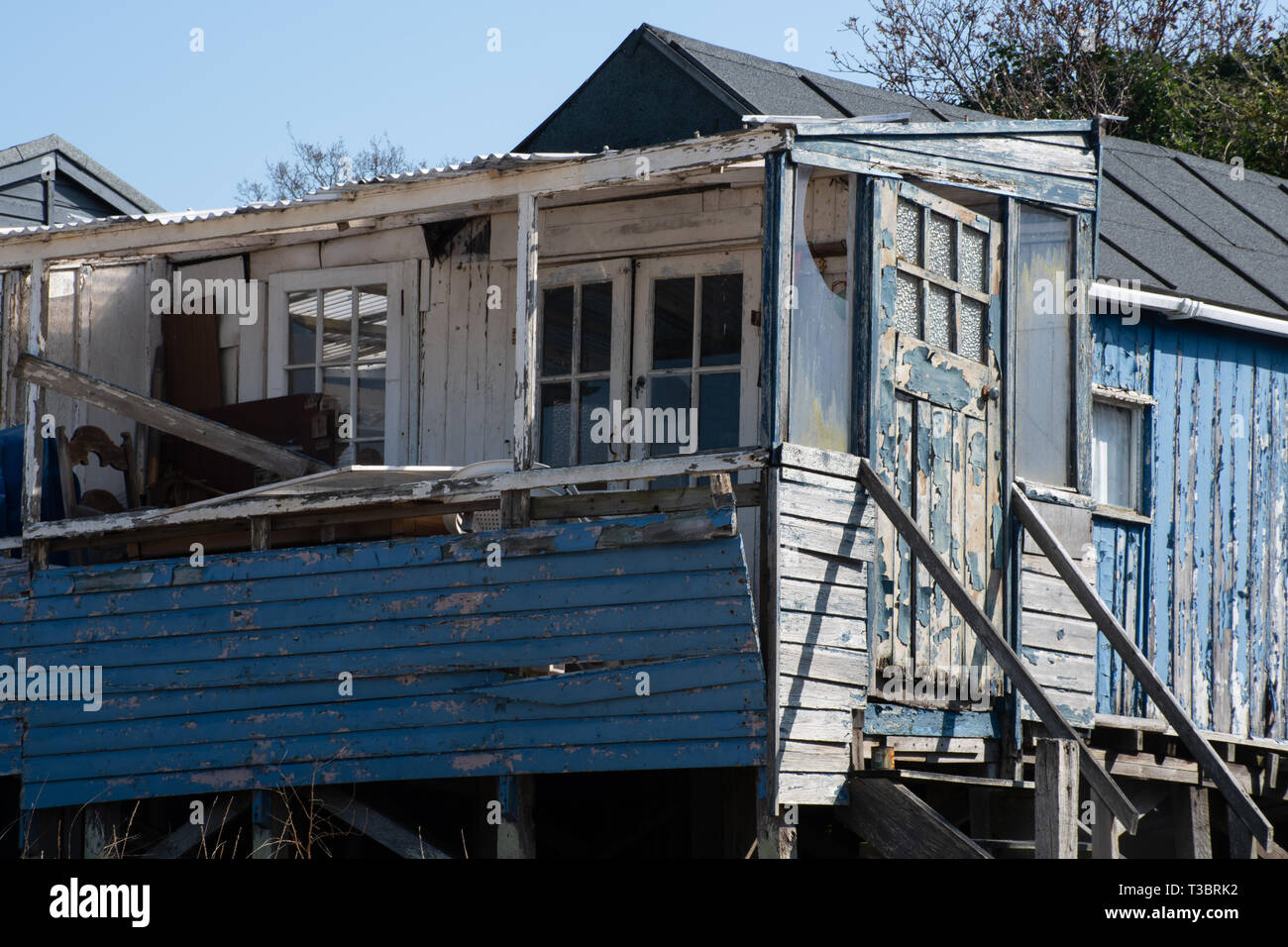 Run down blue wooden coastal shack Stock Photo