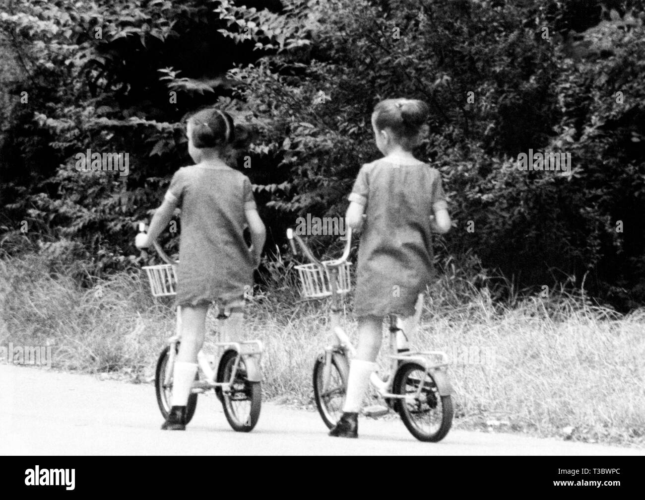 little girls on bicycle, 1960 Stock Photo