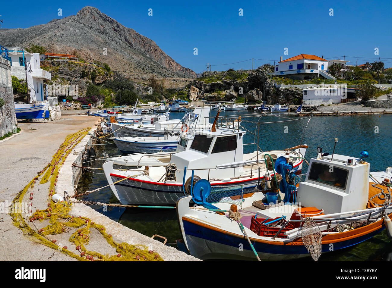 Tiny harbour and fishing boats at village of Profitis Ilias,near Neapoli Voion, Spring, springtime, Peleponnese, Greece, Greek Stock Photo