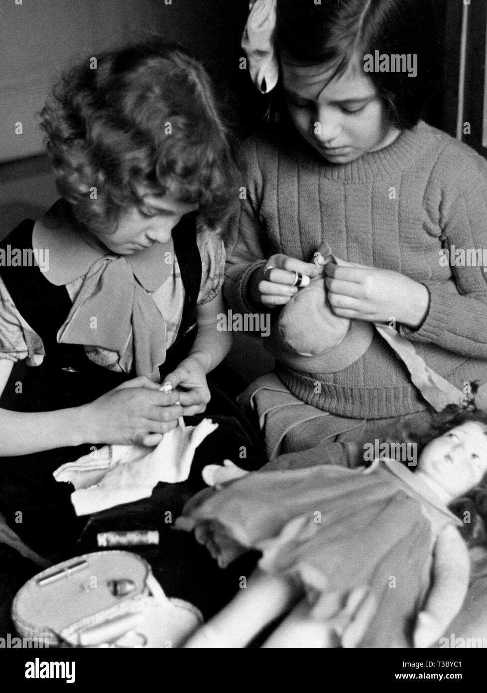 little girls playing with doll, november 1949 Stock Photo