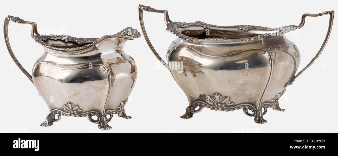 A silver tea service, James Dixon & Sons, Sheffield, circa 1900 Sterling silver. Service consisting of a tray, tea pot, sugar bowl and creamer. The vessels in a curved shape with lavishly profiled rims, English baroque style. All parts with English hallmarks and manufacturer's mark Dixon & Sons, next to it importer's stamp 'Gebr. Friedländer' (Berlin) and German mark of fineness '925'. Width of the tray 60.5 cm, total weight 3980 g. historic, historical, 1900s, 20th century, 19th century, handicrafts, handcraft, craft, object, objects, stills, cl, Additional-Rights-Clearance-Info-Not-Available Stock Photo
