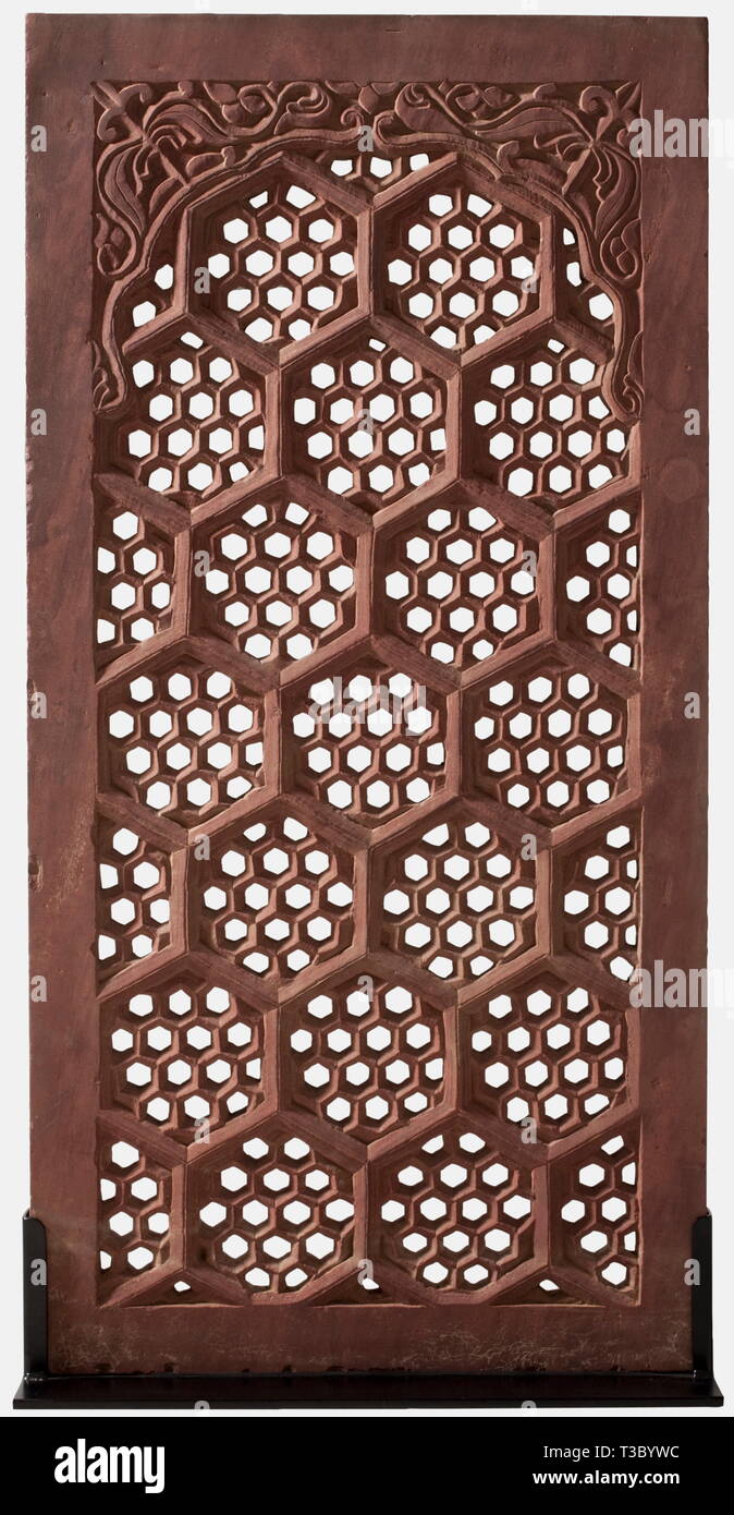A Northern Indian window grille made from sandstone, 19th century Rectangular grille made in one piece from reddish sandstone with geometrical, honeycombed openings. The upper part with floral decorations in relief. One side somewhat patinated. On a modern iron stand. Dimensions 65.3 x 131.5 cm x 4.2 cm. Weight circa 80 kg. historic, historical, 19th century, object, objects, stills, clipping, clippings, cut out, cut-out, cut-outs, fine arts, art, artful, Additional-Rights-Clearance-Info-Not-Available Stock Photo