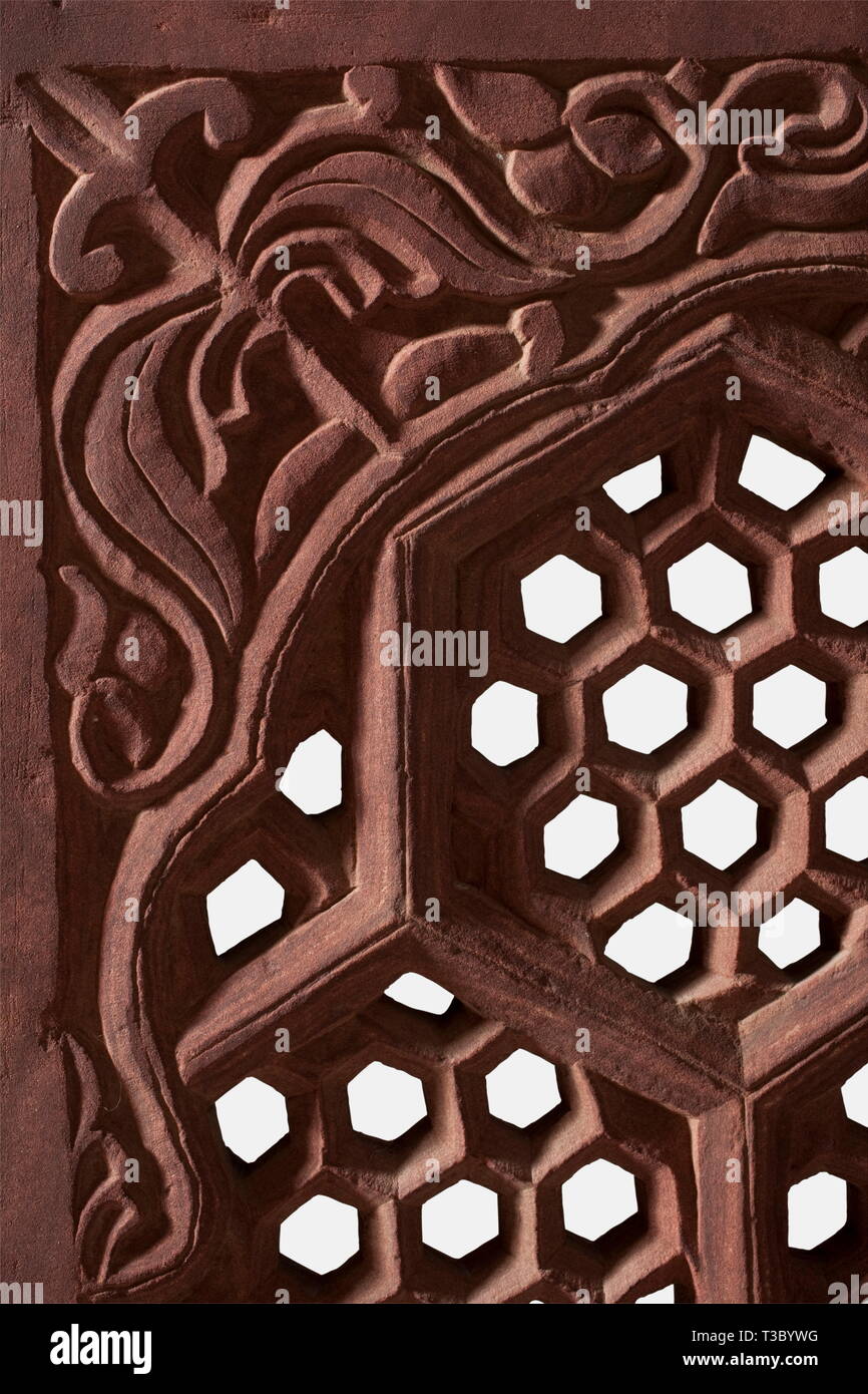 A Northern Indian window grille made from sandstone, 19th century Rectangular grille made in one piece from reddish sandstone with geometrical, honeycombed openings. The upper part with floral decorations in relief. One side somewhat patinated. On a modern iron stand. Dimensions 65.3 x 131.5 cm x 4.2 cm. Weight circa 80 kg. historic, historical, 19th century, fine arts, art, artful, Additional-Rights-Clearance-Info-Not-Available Stock Photo