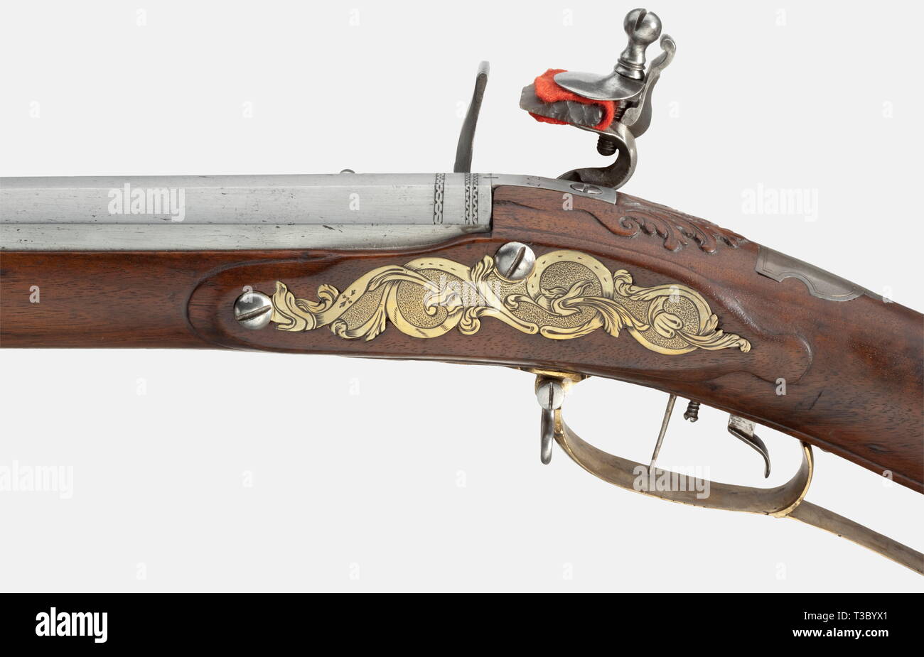 A flintlock rifle, German, 1730/40. Octagonal rifled barrel in 14 mm calibre. Brass front sight and folding rear sight. The chamber and muzzle are modestly engraved. The tang is inscribed '12'. Flintlock engraved with hunting themes. Adjustable set trigger. Walnut full stock with brass furniture decorated with scrollwork. Silver escutcheon. Patchbox. Wooden ramrod with horn tip. Length 109 cm. Provenance: Christie's, Bedeutende Europäische Waffen, Dusseldorf 1972, lot 101. historic, historical, 18th century, civil long guns, gun, weapons, arms, w, Additional-Rights-Clearance-Info-Not-Available Stock Photo