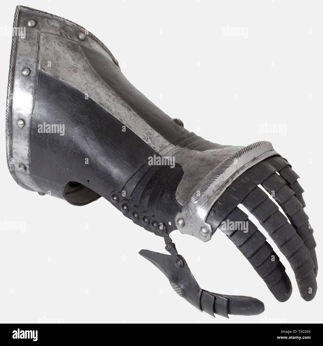 A pair of German black and white fingered gauntlets, circa 1580 Articulated metacarpus of five lames with raised cabled knuckle protection. Articulated finger defences and hinged thumb plates. Pointed cuffs set with turned under and roped edge. An armoury mark consisting of three dots at the edge. Length 35 cm each. historic, historical, 16th century, defensive arms, weapons, arms, weapon, arm, fighting device, object, objects, stills, clipping, clippings, cut out, cut-out, cut-outs, utensil, piece of equipment, utensils, plating, armour-plating,, Additional-Rights-Clearance-Info-Not-Available Stock Photo