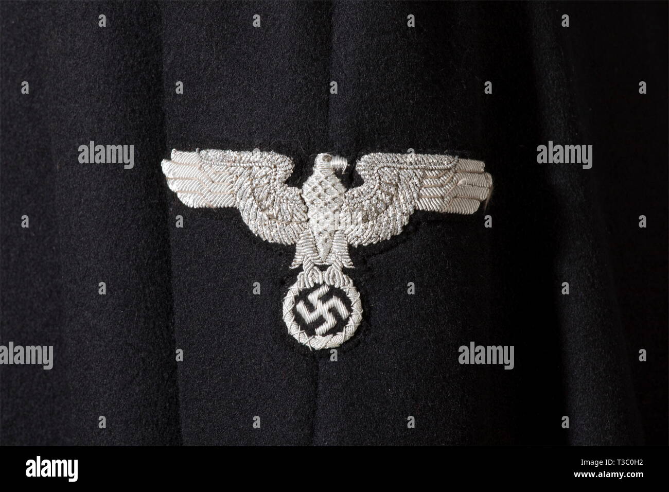 A cloak to the black uniform, for SS-leaders Cloak of black woolen material with hidden button facing and silver collar cord, in the black liner a tailor's tag 'Nic Reuter - Düsseldorf - Königsallee 64', in the interior pocket a wearer's label. Aluminium clasp with chain, the buttons with applied SS eagles. Silver-embroidered sleeve eagle. Of extreme rareness. historic, historical, 1930s, 1930s, 20th century, Waffen-SS, armed division of the SS, armed service, armed services, NS, National Socialism, Nazism, Third Reich, German Reich, Germany, military, militaria, utensil, p, Editorial-Use-Only Stock Photo