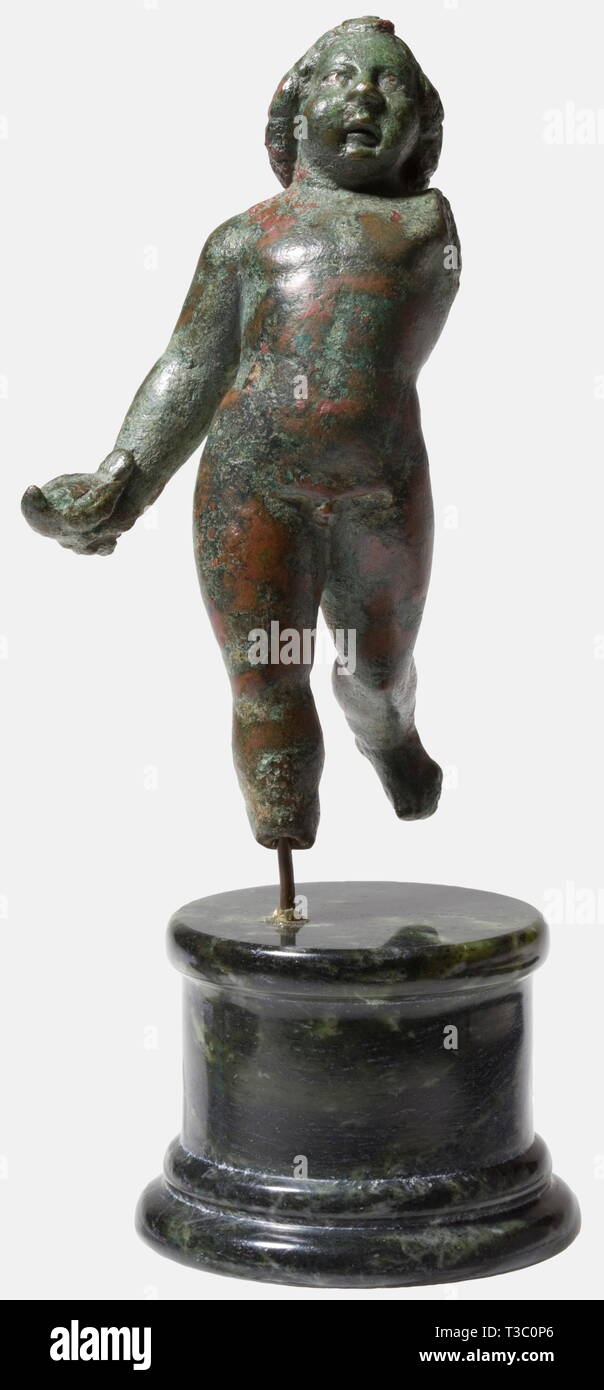 A boy with a pigeon, Roman, 2nd century A.D. Cast bronze complemented by cold-working. Finely modelled figure striding forward, holding in his right hand a pigeon, his face finely crafted, the curly hair elaborately dressed. Height 11.5 cm. Dark green to brownish patina, the metal well preserved, one arm and the right foot missing. Provenance: German private collection, 1970s. historic, historical, 20th century, ancient world, ancient world, ancient times, object, objects, stills, clipping, cut out, cut-out, cut-outs, sculpture, sculptures, statu, Additional-Rights-Clearance-Info-Not-Available Stock Photo