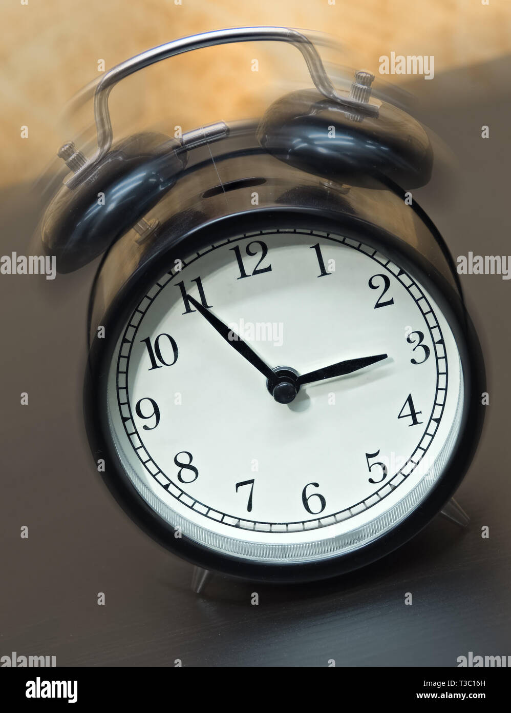 Old fashioned black alarm clock vibrating Stock Photo Alamy