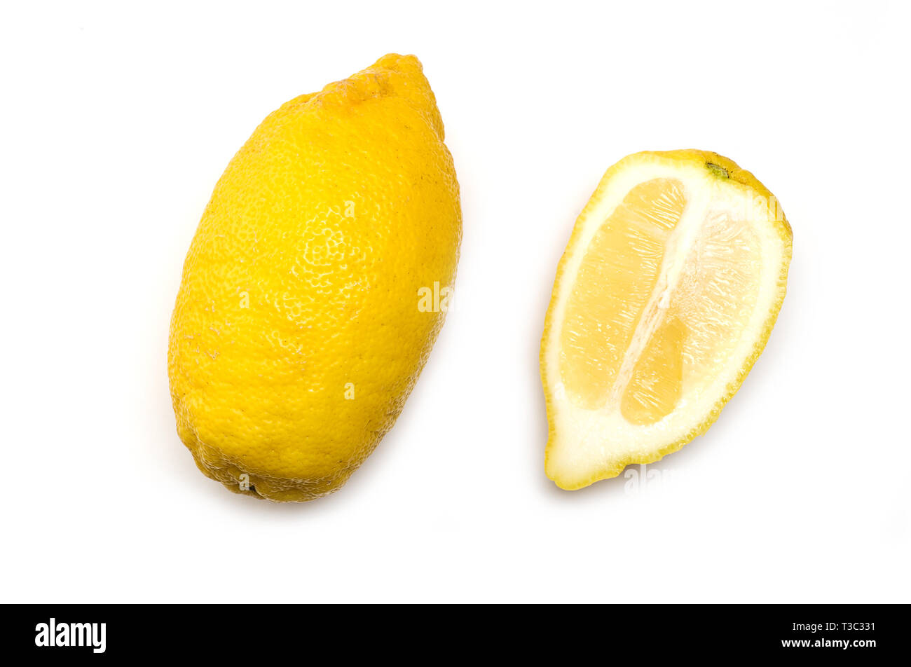 Trendy ugly organic lemons from home garden.One whole and second half. Healthy eating concept.Vitamins. Stock Photo