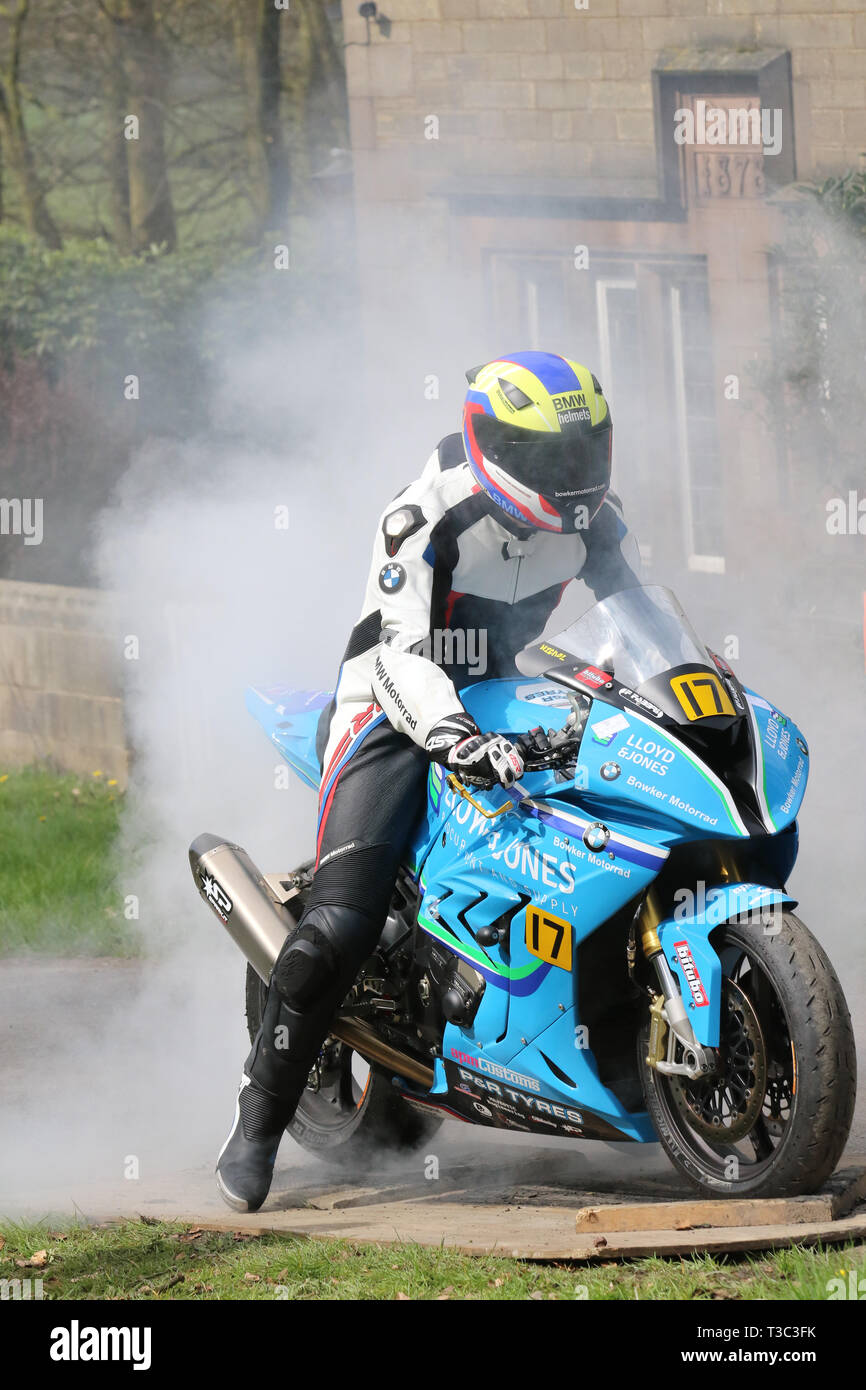 Chorley, Lancashire, UK. 7th April, 2019. Hoghton Tower 43rd Motorcycle Sprint. Rider 17 John Nichol from Lytham St Annes riding 2010 BMW S1000 RR S1000RR, a modern superbike.  Motorcycle wheel burning tires and smoking on race track, sport motorcycle burnout with lots of smoke and rubber. Stock Photo