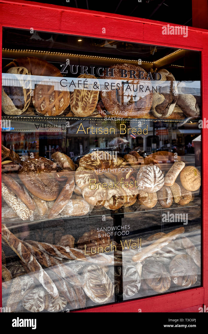 Shop window bread display featuring an assortment of produce for sale. Stock Photo