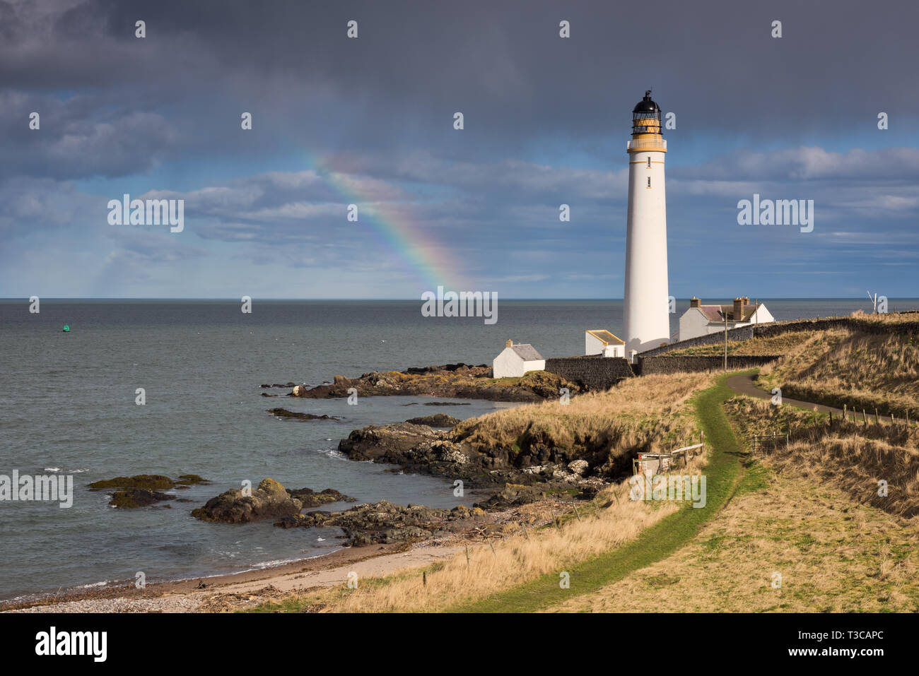 Scurdie Ness lighthouse on the Montrose headland with a rainbow out at