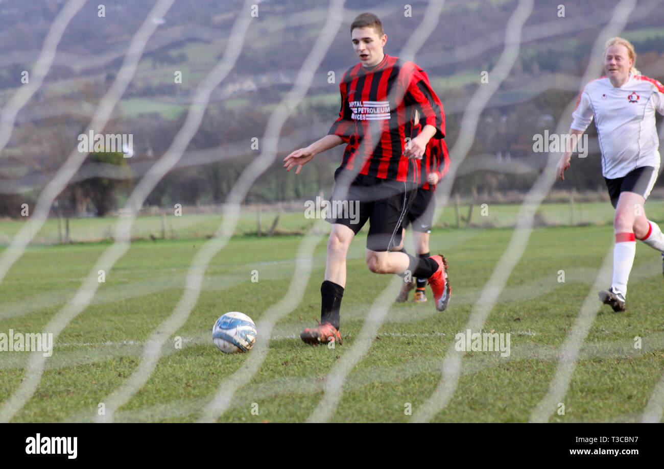 Football player running through on goal Stock Photo Alamy