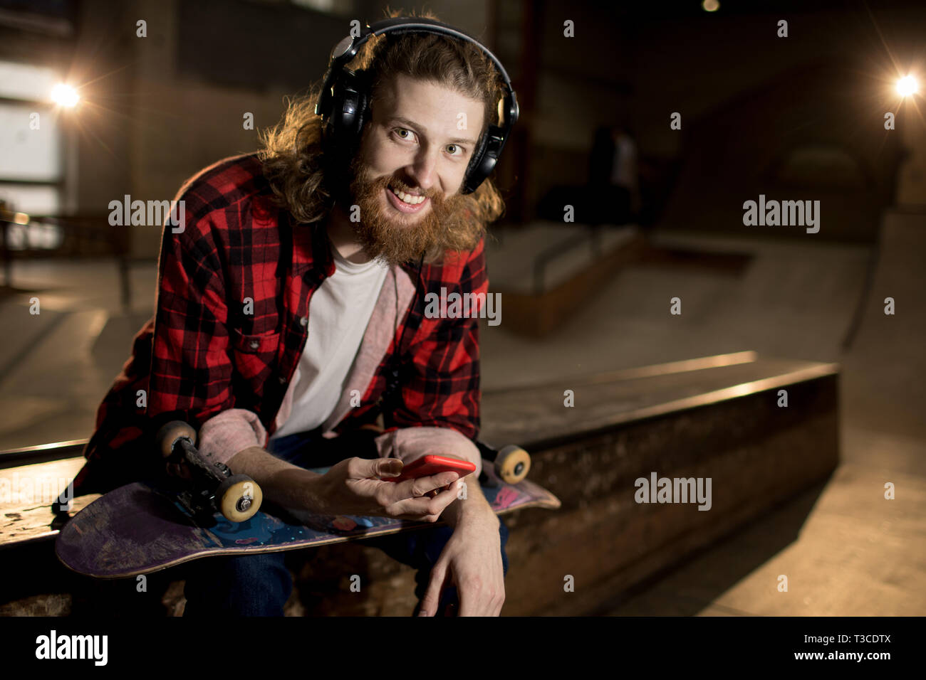Smiling man headphones holding hi-res stock photography and images - Alamy