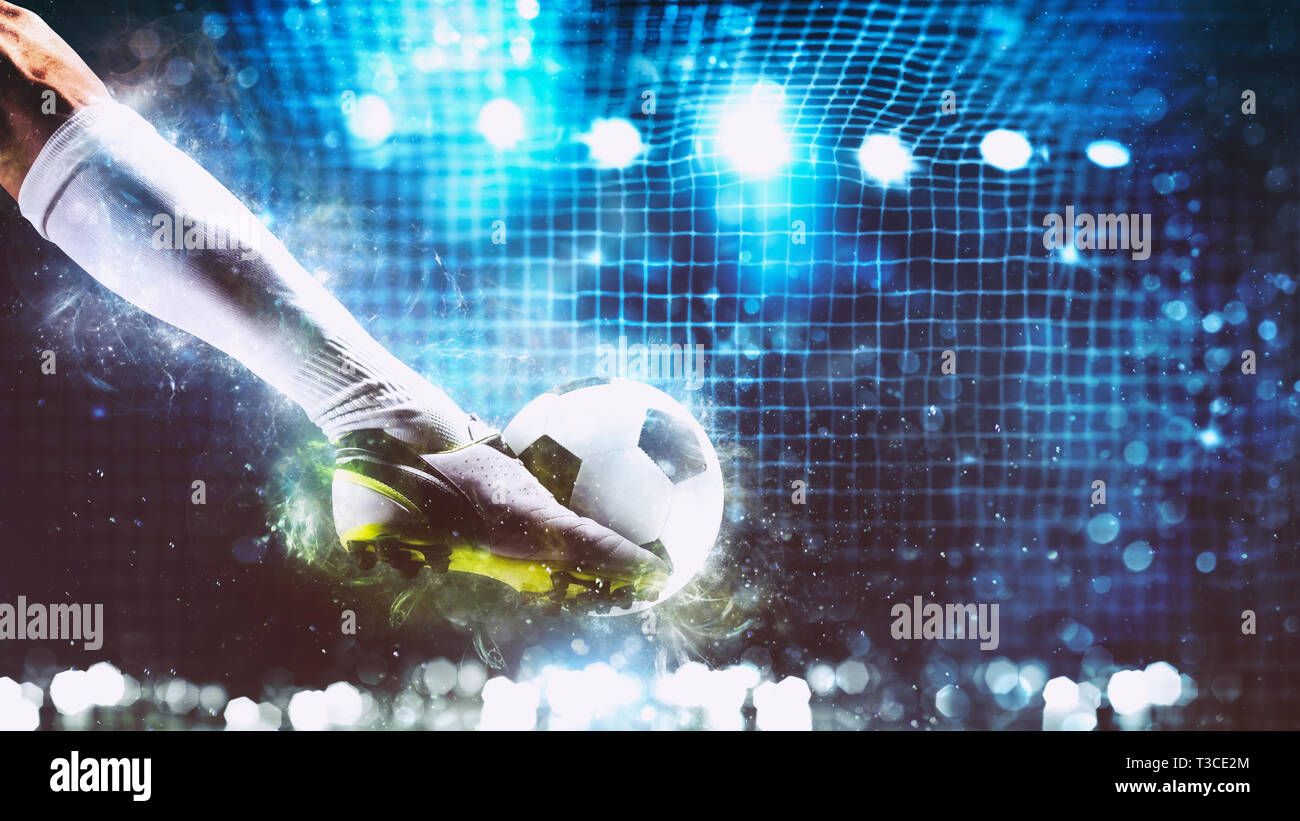 Football scene at night match with player ready to shoot the ball Stock Photo