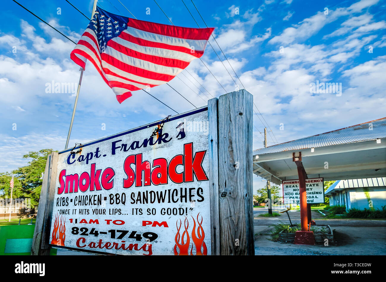 An American flag flies above Capt. Frank’s Smoke Shack, Aug. 15, 2015, in Bayou La Batre, Alabama. Stock Photo