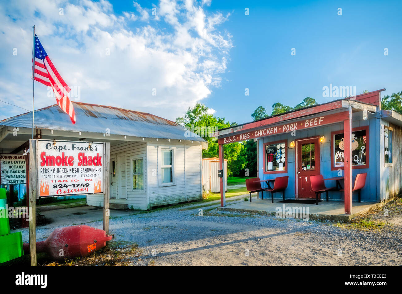 Capt. Frank’s Smoke Shack is pictured beside Johnson Agency real estate office, Aug. 15, 2015, in Bayou La Batre, Alabama. Stock Photo