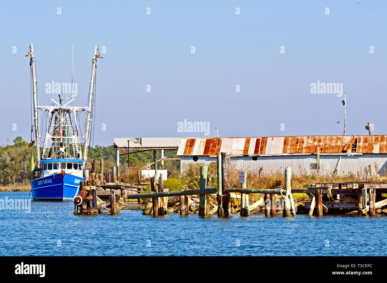A shrimp boat, the Iron Eagle, is docked at a wharf at the Bayou La Batre State Docks in Bayou La Batre, Alabama, Nov. 23, 2012. Stock Photo