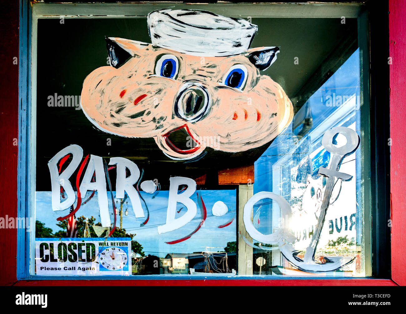 A cartoon pig is painted on the window at Capt. Frank’s Smoke Shack, Aug. 15, 2015, in Bayou La Batre, Alabama. Stock Photo