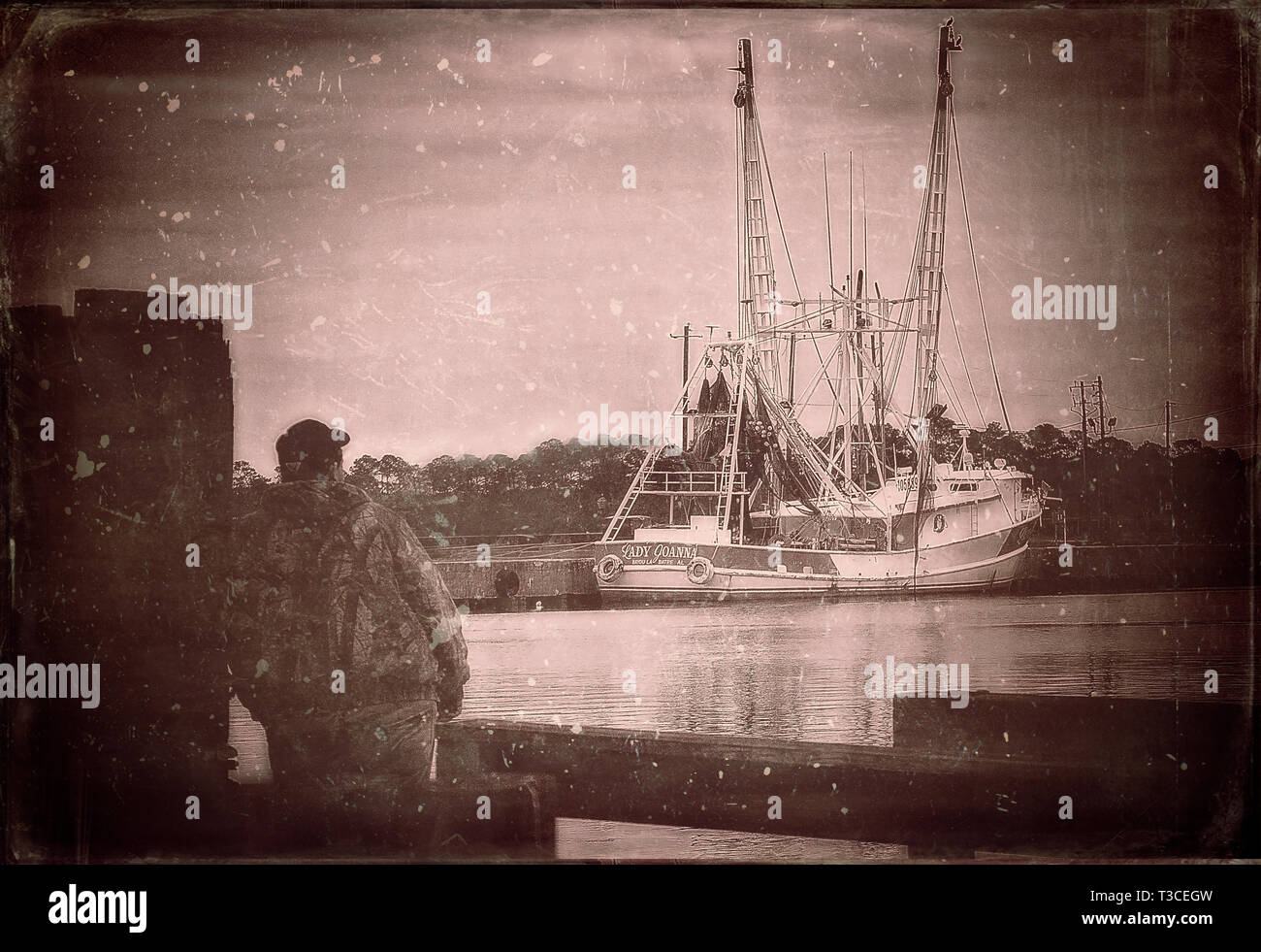 A man stares out at Lady Joanna, a shrimp boat, January 5, 2016, in Bayou La Batre, Alabama. Stock Photo