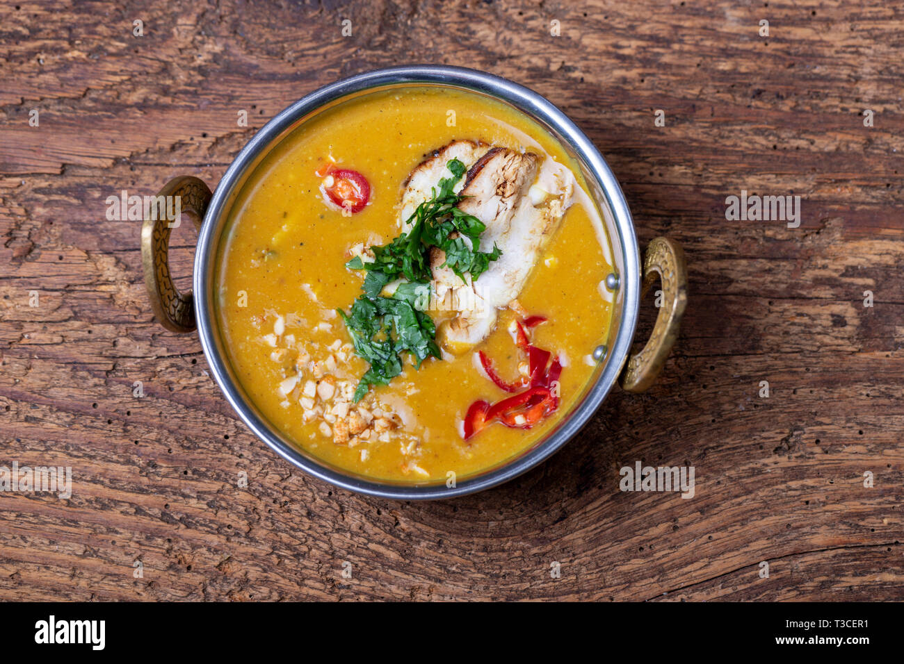 indian Mulligatawny soup in a brass bowl Stock Photo