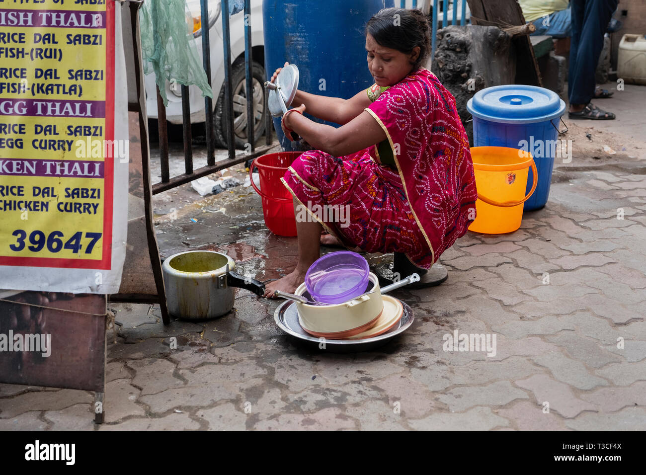 woman washing dishes on the streets of Kolkata, India Stock Photo Alamy
