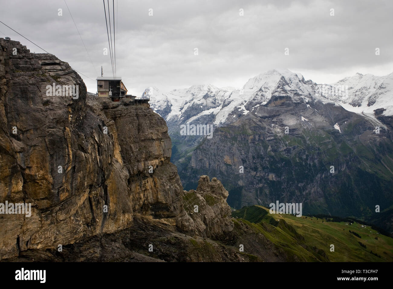 The Birg cablecar station perched above a cliff with the Jungfrau Massif and the Lauterbrunnen valley beyond, Bernese Oberland, Switzerland Stock Photo