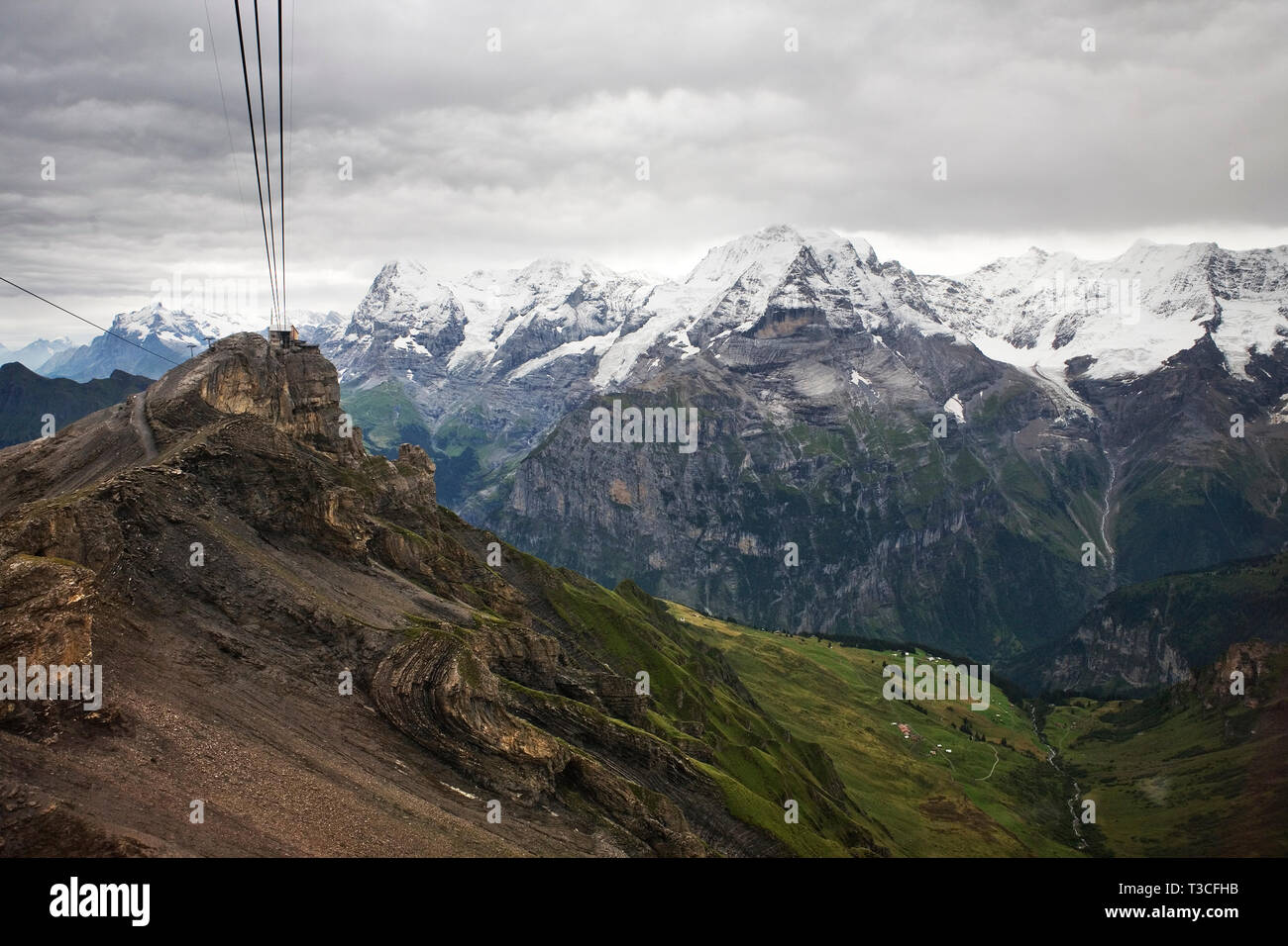 The Birg cablecar station perched above a cliff with the Jungfrau Massif and the Lauterbrunnen valley beyond, Bernese Oberland, Switzerland Stock Photo