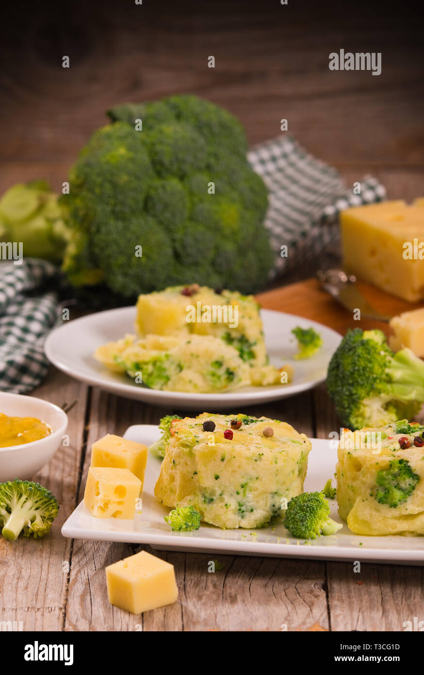 Potato gratins with broccoli florets Stock Photo Alamy