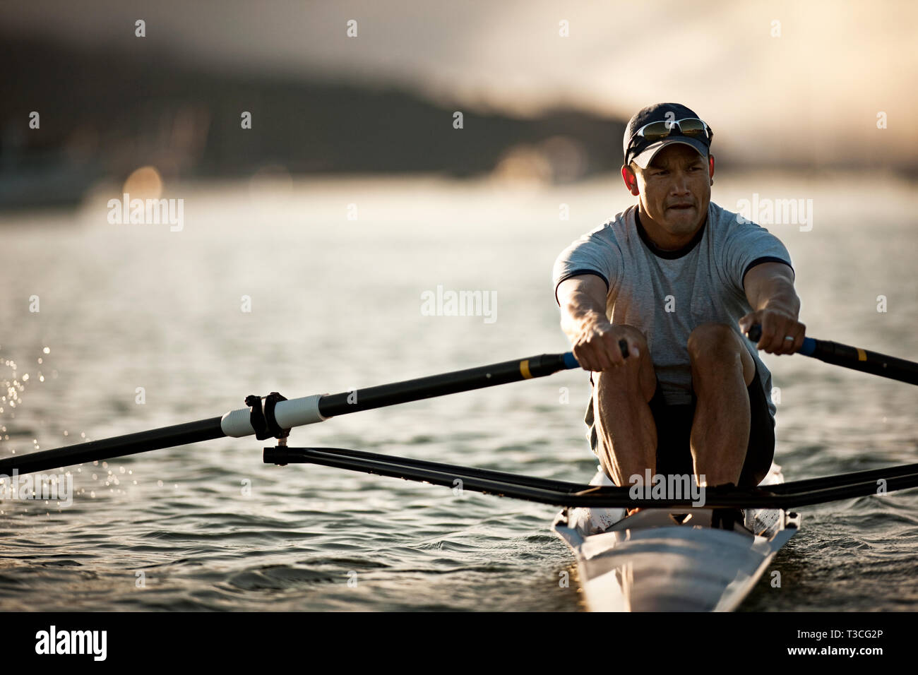 Mid-adult man sea rowing Stock Photo - Alamy