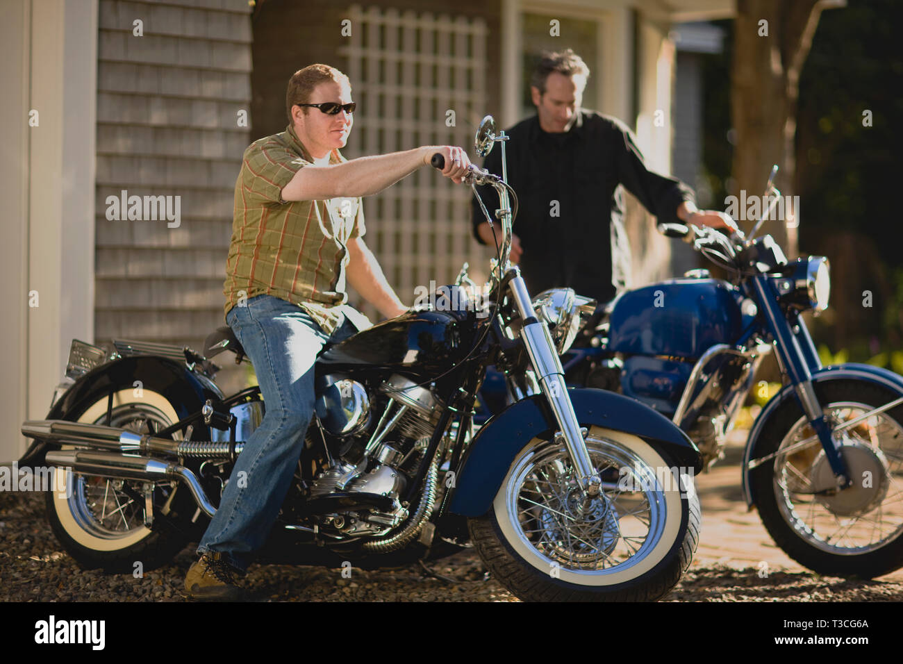 Two men and their motorcycle hobby Stock Photo - Alamy