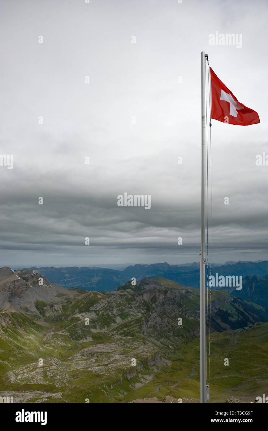 Swiss flag flying on the summit of the Schilthorn, Bernese Oberland, Switzerland Stock Photo