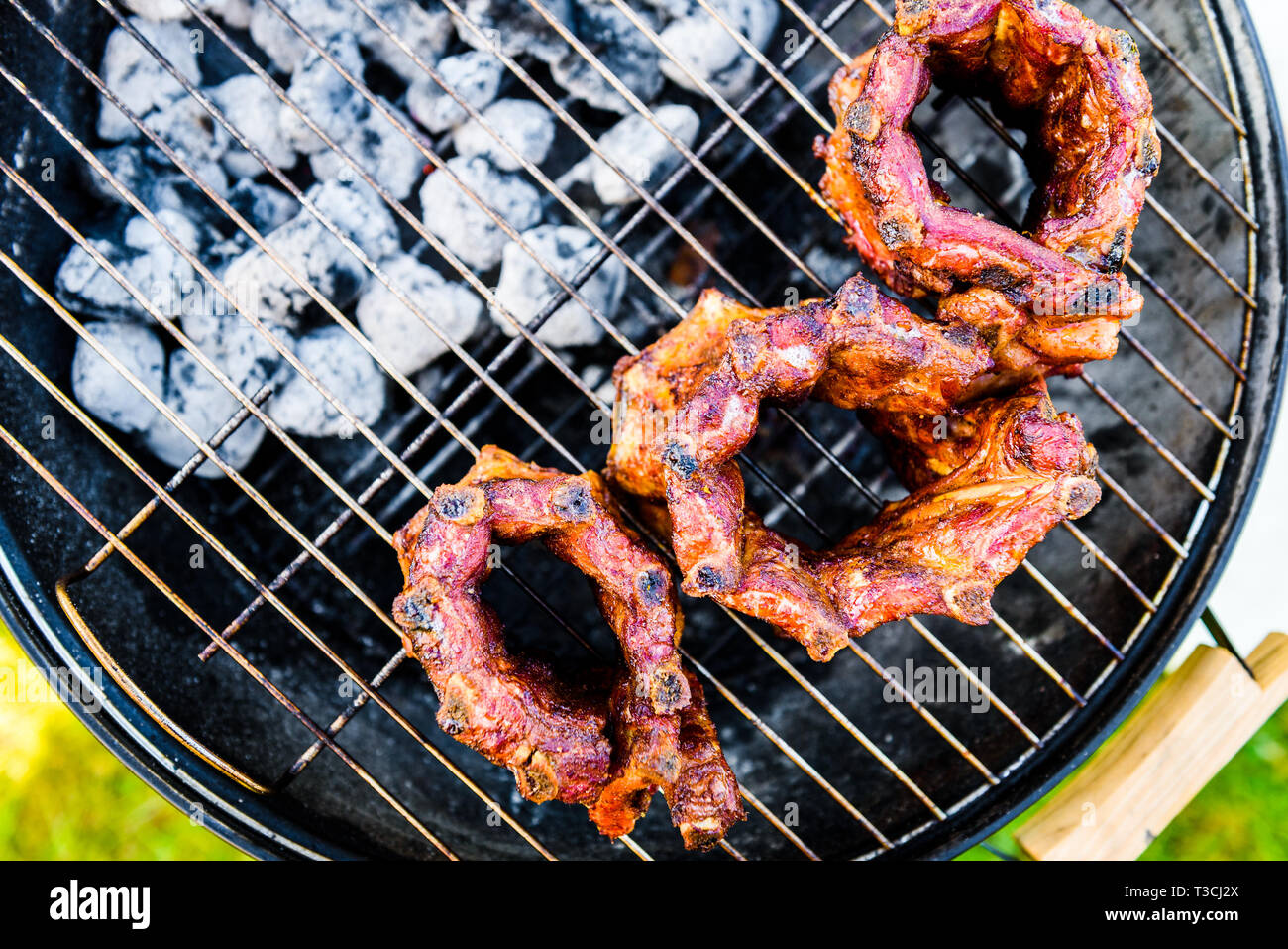 Baby Back Ribs Crown Roast on BBQ barbecue kettle grill. Home made pork