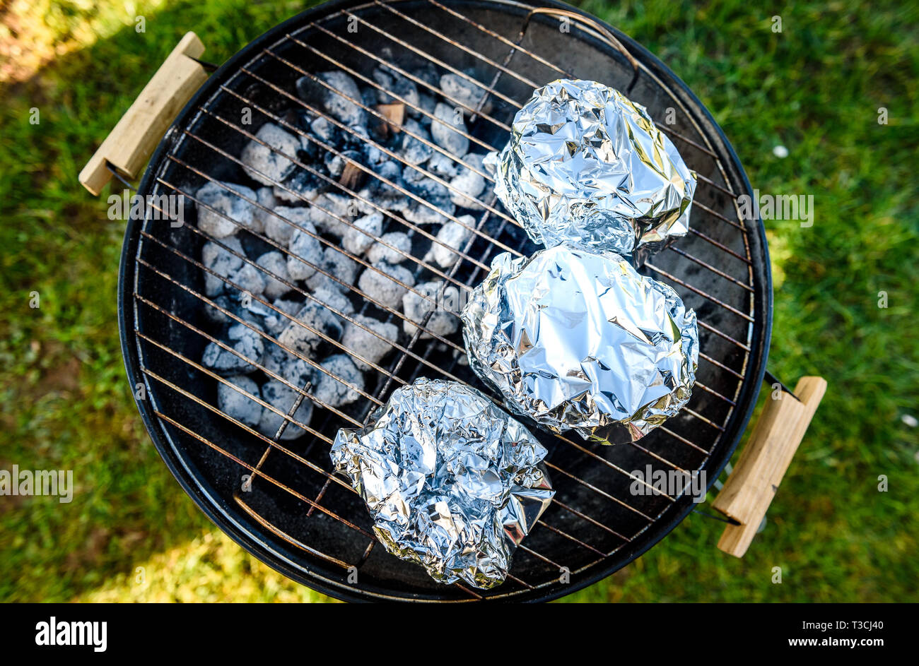 Baby Back Ribs Crown Roast on BBQ barbecue kettle grill. Home made pork