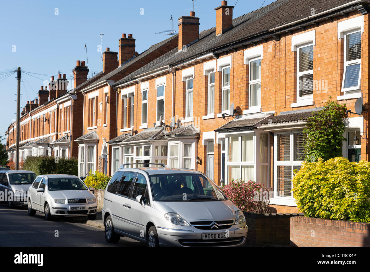 Terraced brick housing, concept - the UK housing market, economy, house prices, renting, mortgages, rental market, letting, landlords Stock Photo