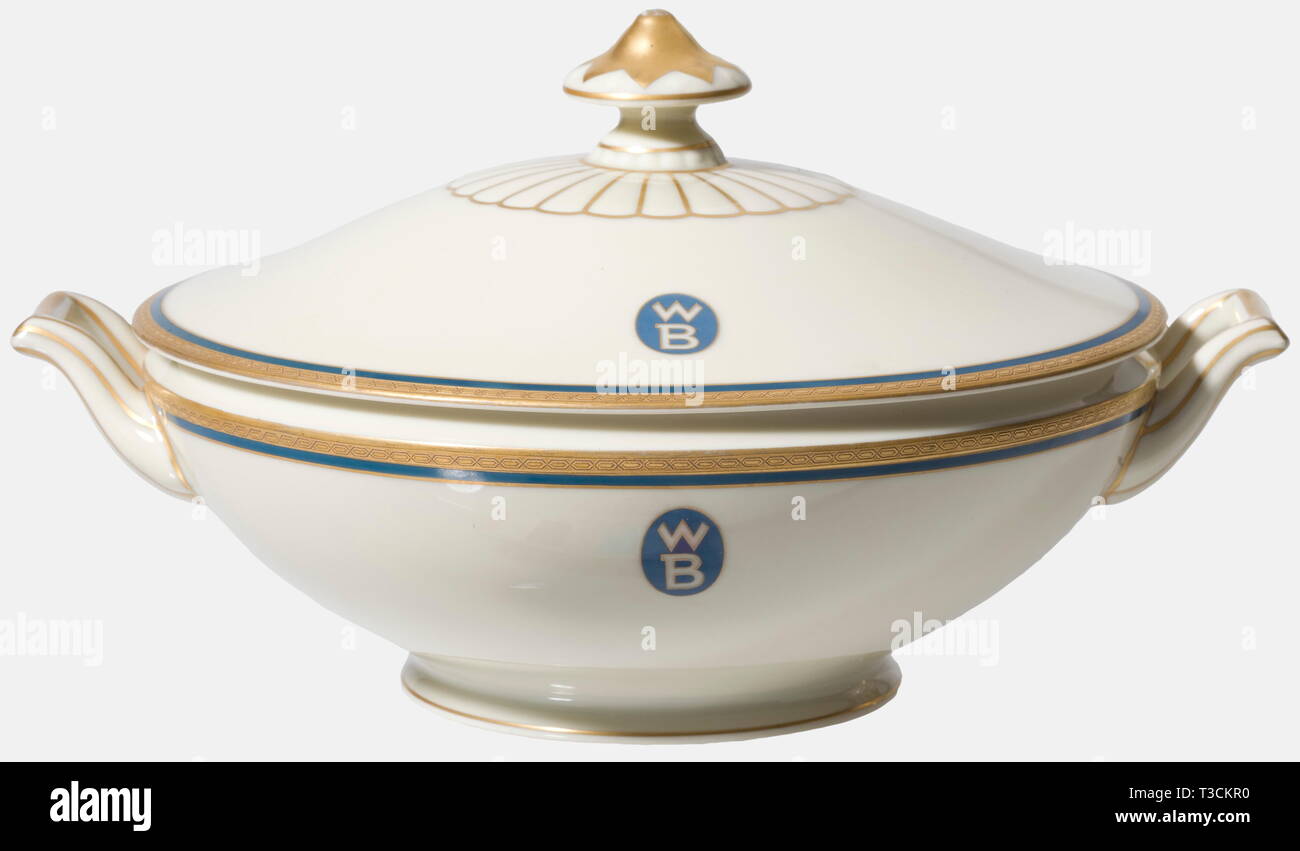 A bowl from the dining service, of the Zeppelin Shipping Line Bowl with lid, etched gold décor border set off in blue, the blue/gold emblem of the Zeppelin Shipping Line with opposing 'WB' within a blue oval. On the bottom the manufacturer's marks 'Selb Bavaria, Heinrich & Co' and 'Heinrich Elfenbein-Porzellan'. Diameter 21 cm, height 15 cm. historic, historical, 20th century, transport, transportation, object, objects, stills, tureen, tureens, dish, dishes, porcelain, chinaware, Additional-Rights-Clearance-Info-Not-Available Stock Photo