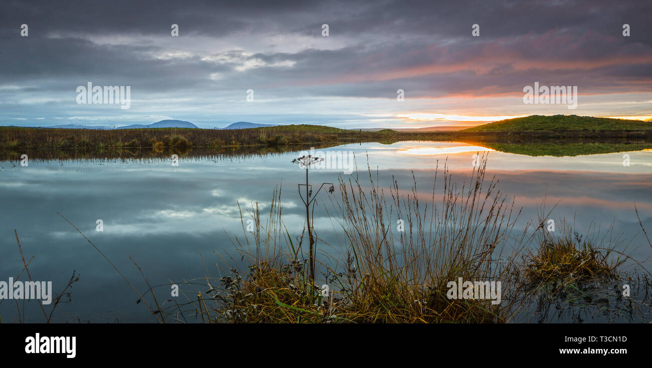 Sunset view across the Loch of Harray toward Hoy, Orkney Islands. Stock Photo