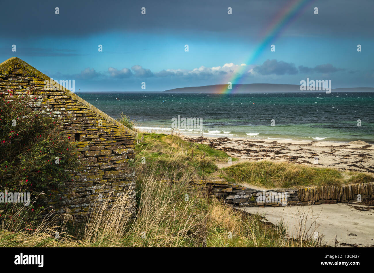 Rainbow over Eynhallow Sound from Evie, Mainland, Orkney Islands. Stock Photo