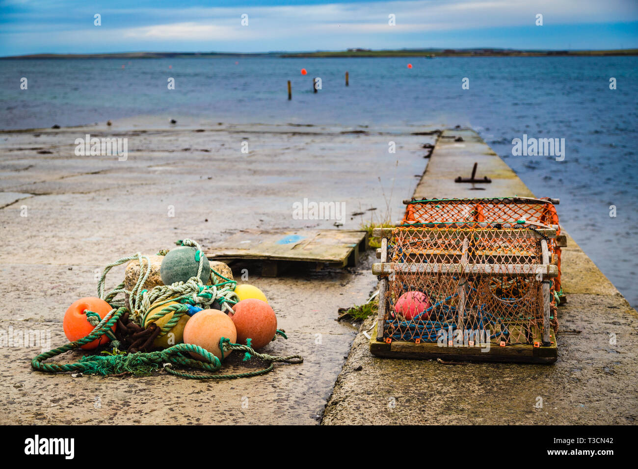 Lobster creels and buoys on a slipway in Kirkwall, Orkney Islands. Stock Photo