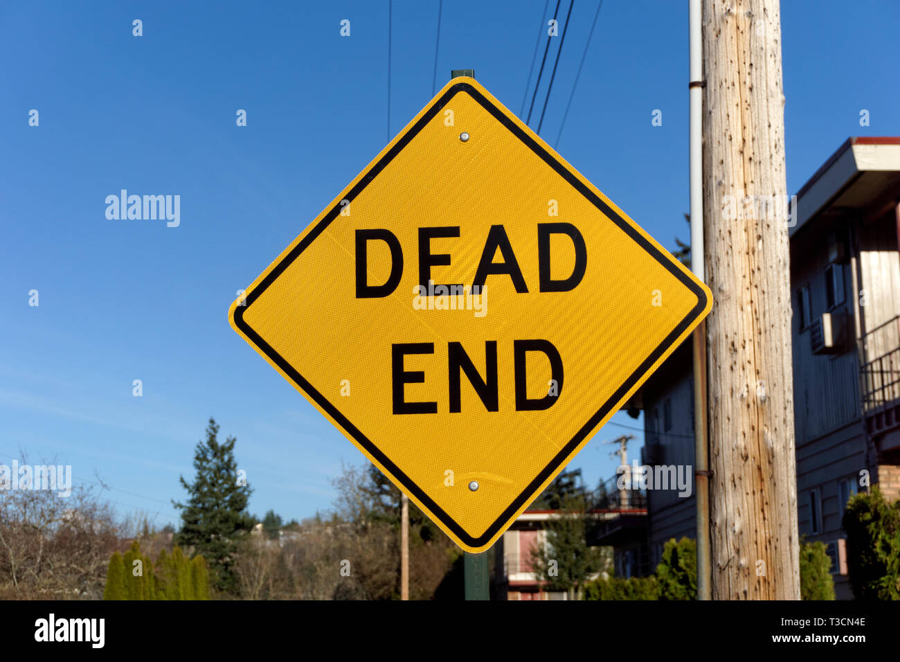 Yellow and black Dead End sign on a residential street Stock Photo