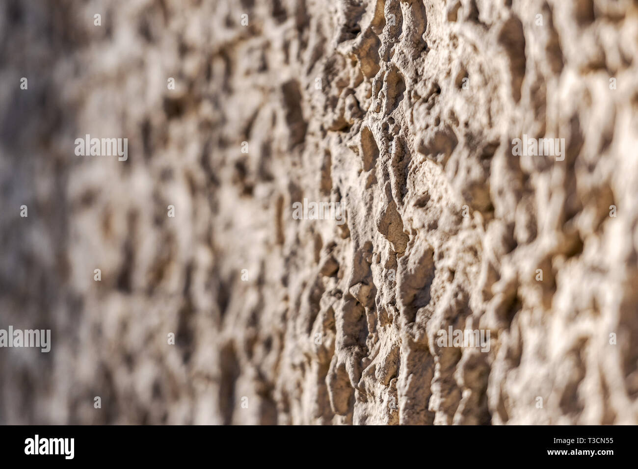Decorative exterior wall plaster with embossed surface. Selective focus image Stock Photo