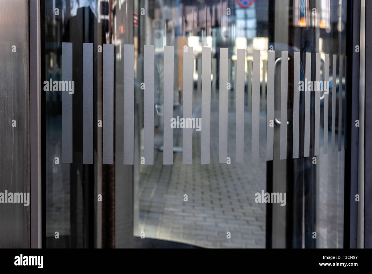 close-up of modern secured glass door fragment at corporate business building. - Image Stock Photo