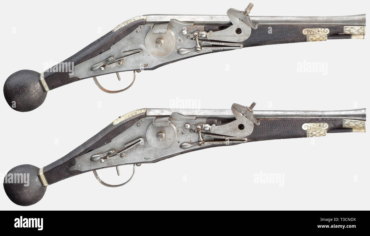A pair of Saxon wheellock puffers, Historismus period in the style of 1600. Two-stage barrels, octagonal breech section, then round with smooth bores in 14 mm calibre and swamped muzzles. Inscribed 'NFH' on each chamber. Iron wheellocks. Ebonised pebbled stocks with engraved and blackened bone inlays. Wooden ramrods with bone tips. Some insect damage to both stocks. Length of each 57 cm. historic, historical, 17th century, handgun, handheld, firearms, military, militaria, firearm, fire arm, gun, fire arms, firearms, guns, weapon, arms, weapons, a, Additional-Rights-Clearance-Info-Not-Available Stock Photo
