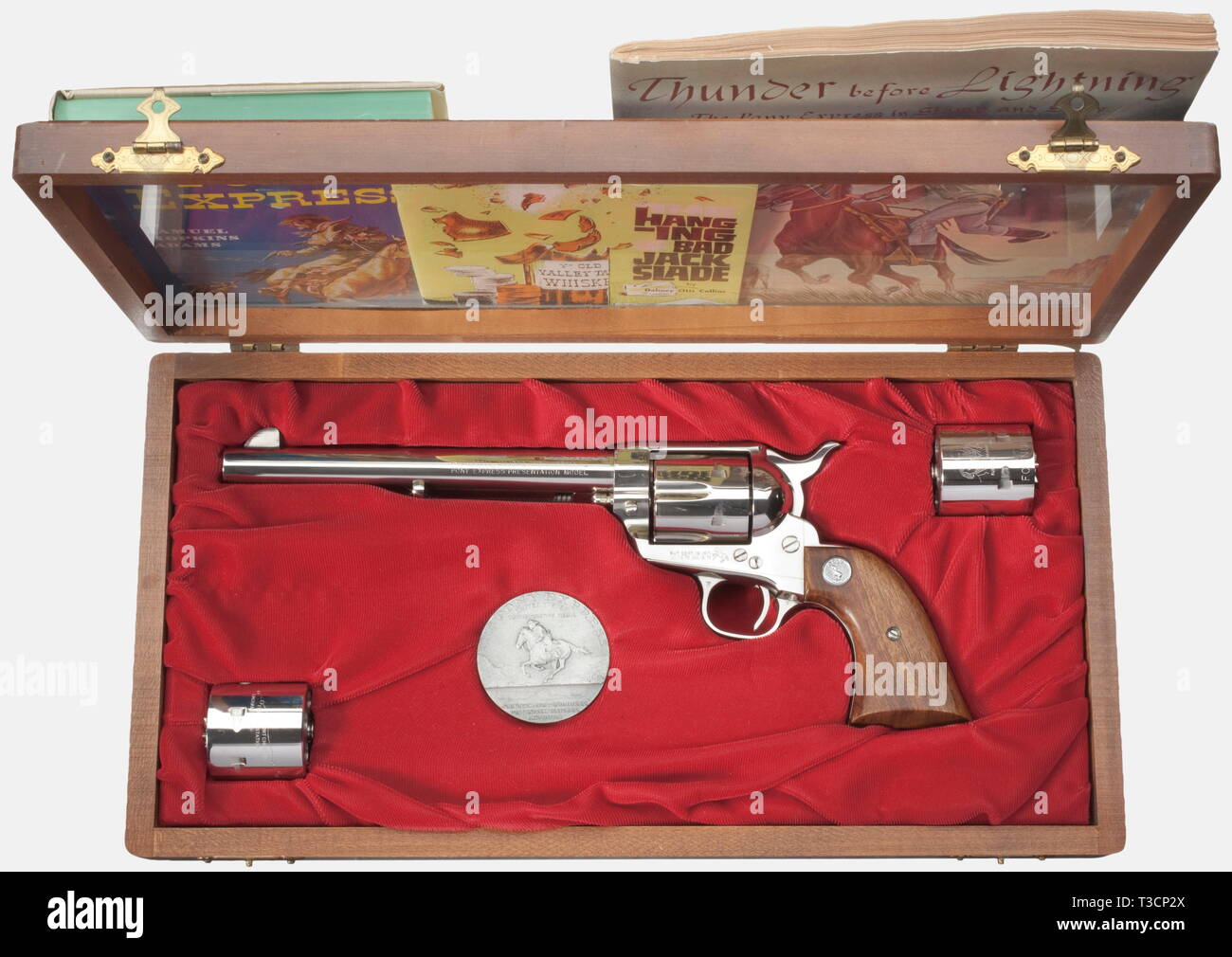 A Colt SAA 'Pony Express', cal..45LC, no. PE151-E, production year 1964. Bright bore, 7.5'-barrel with standard inscription on upper side, marked 'Colt Peacemaker' on the right. On the left side marked 'Russell, Majors and Waddell Pony Express Presentation Model'. Cylinder with German proof mark. Completely nickel-plated, walnut grip panels with inlaid Colt logo, grip frame marked 'Sacramento to Friday's Station'. In presentation case plus two engraved spare cylinders with portraits of Pony Express founders and Pony Express route as well as a com, Additional-Rights-Clearance-Info-Not-Available Stock Photo